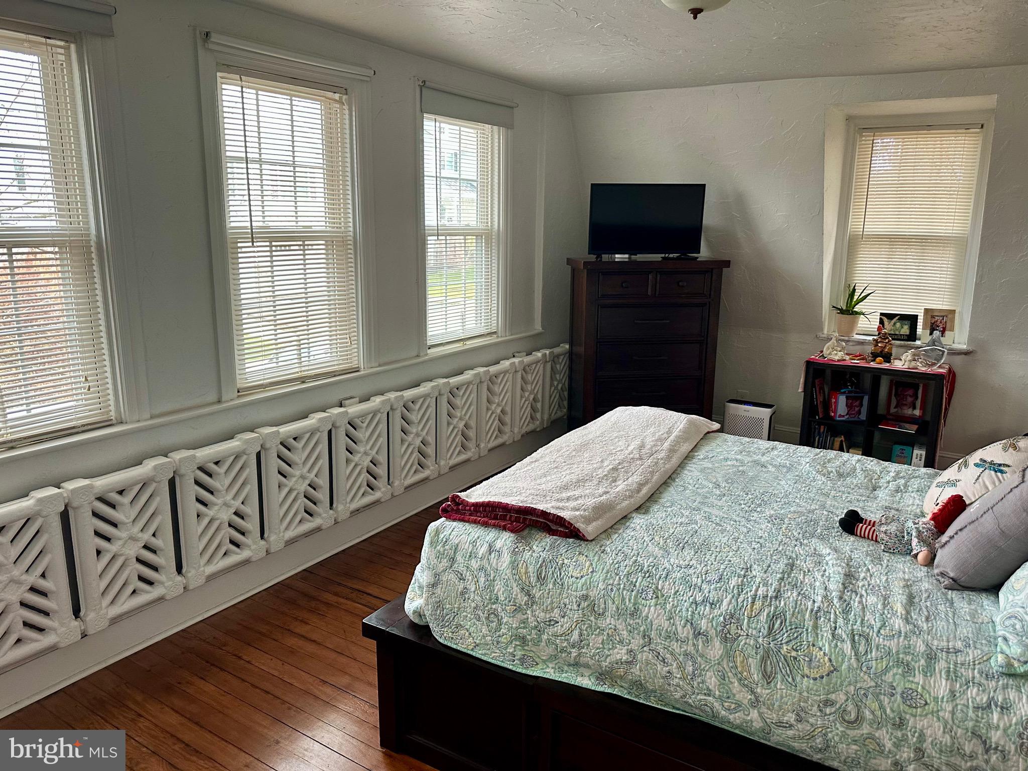 1 West Street, Unit 414 Media, PA 19063 - Photo 19 of 20 a bedroom with a bed and a flat tv screen on dresser