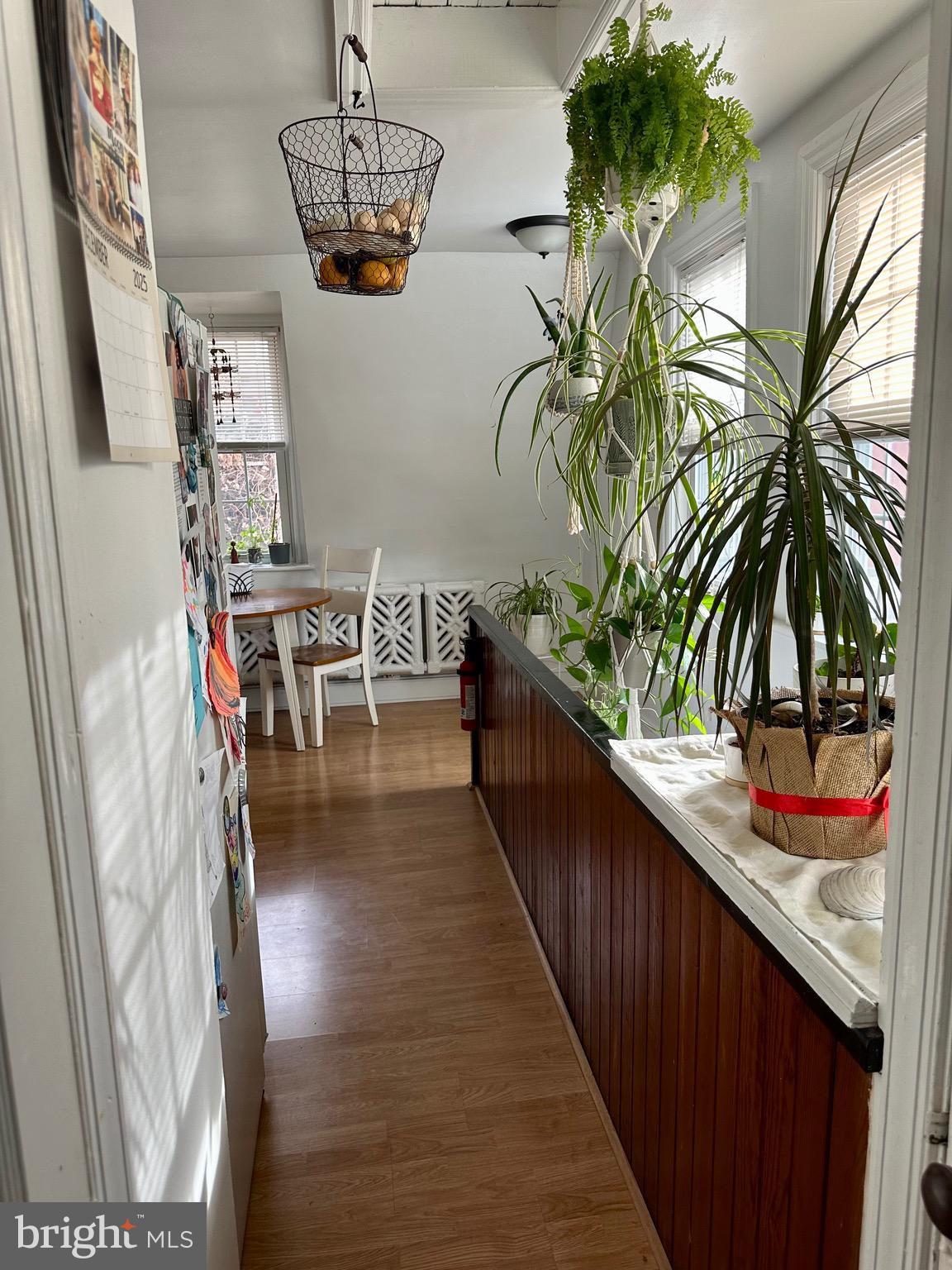 1 West Street, Unit 414 Media, PA 19063 - Photo 9 of 20 a hallway with a dining table and a potted plant
