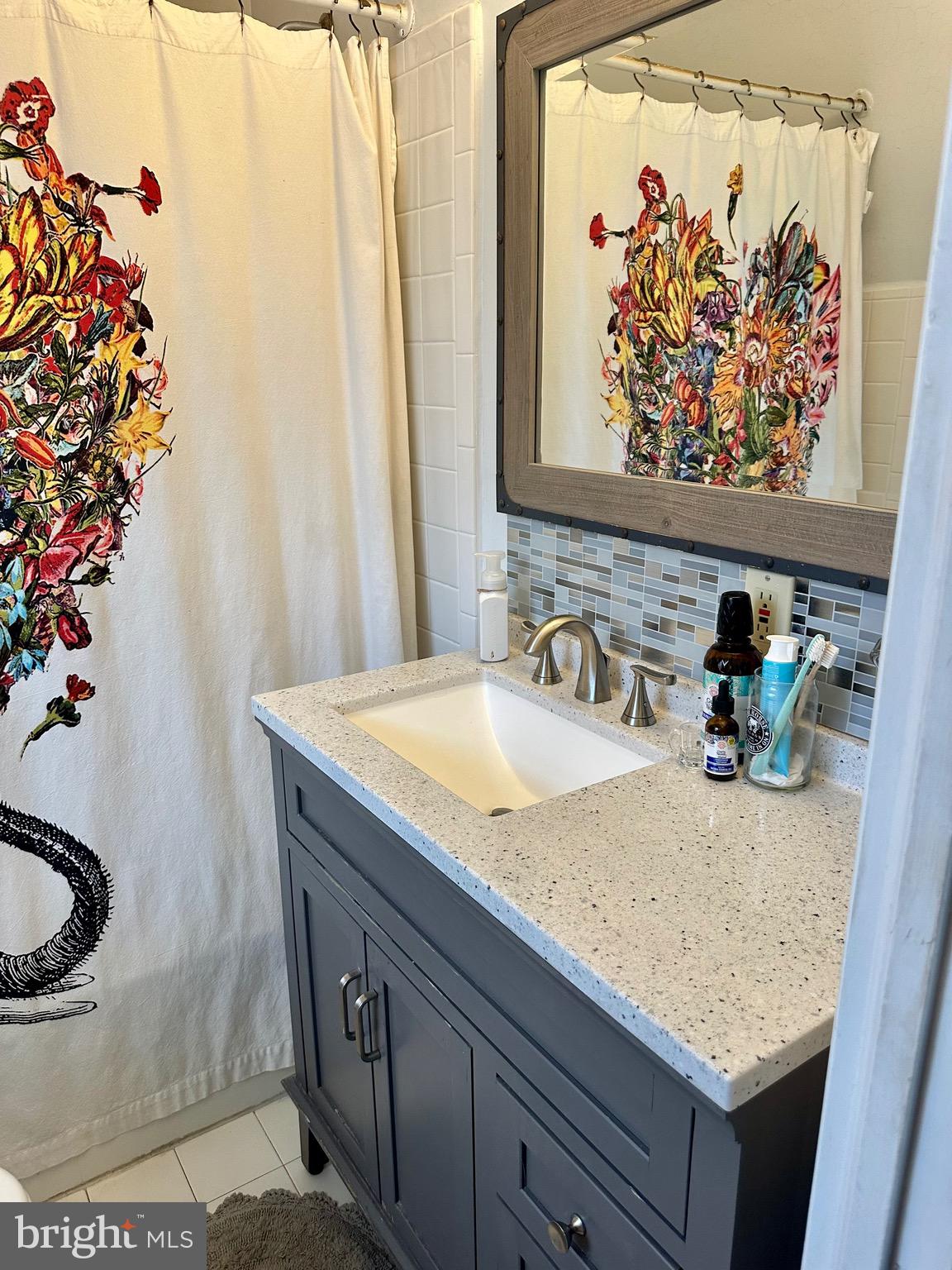 1 West Street, Unit 414 Media, PA 19063 - Photo 10 of 20 a bathroom with a granite countertop sink and a mirror