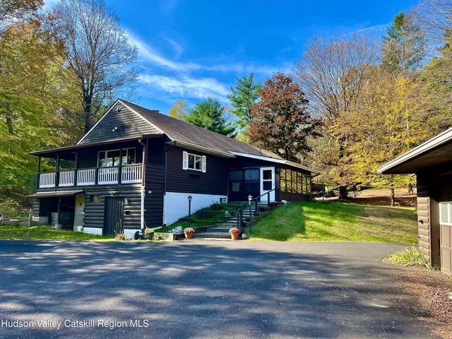 a front view of house with yard and green space