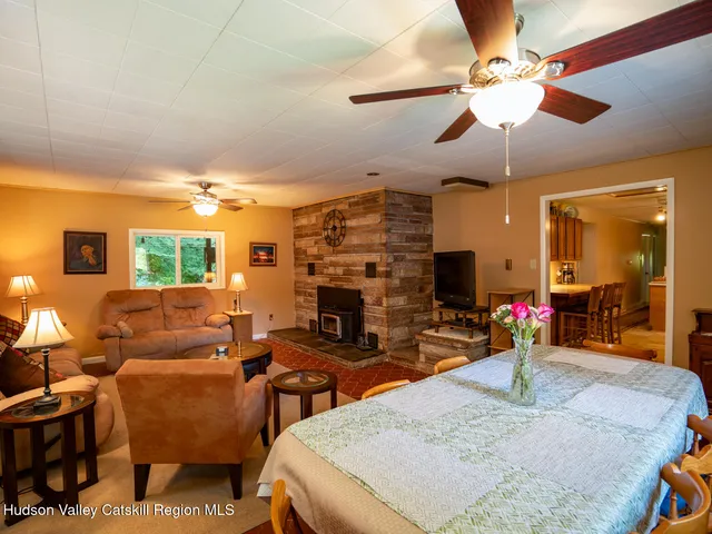 a living room with fireplace furniture and a flat screen tv