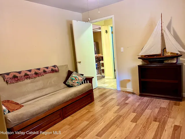 a living room with a couch and a wooden floor