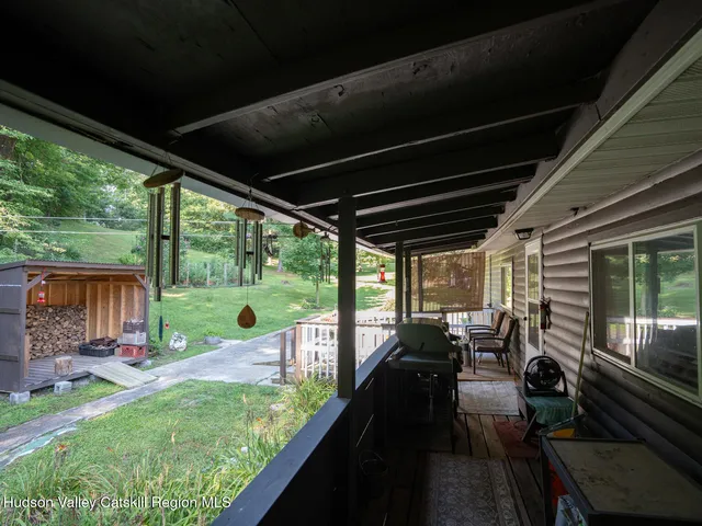 a view of a chairs and table in patio with a yard