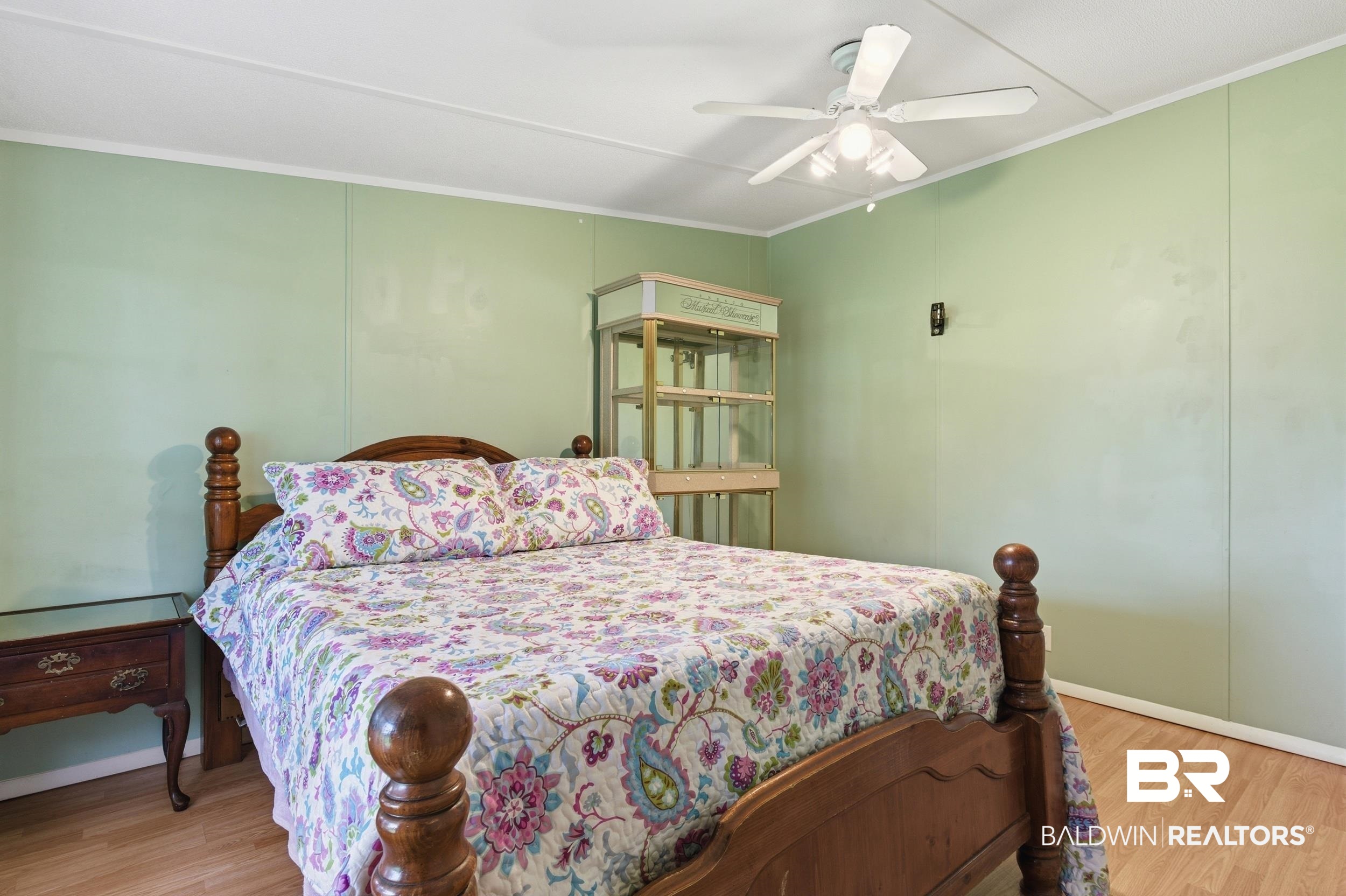 926 Tumbling Lane Atmore, AL 36502 - Photo 39 of 56 Spacious room with wood-finish flooring and light green walls