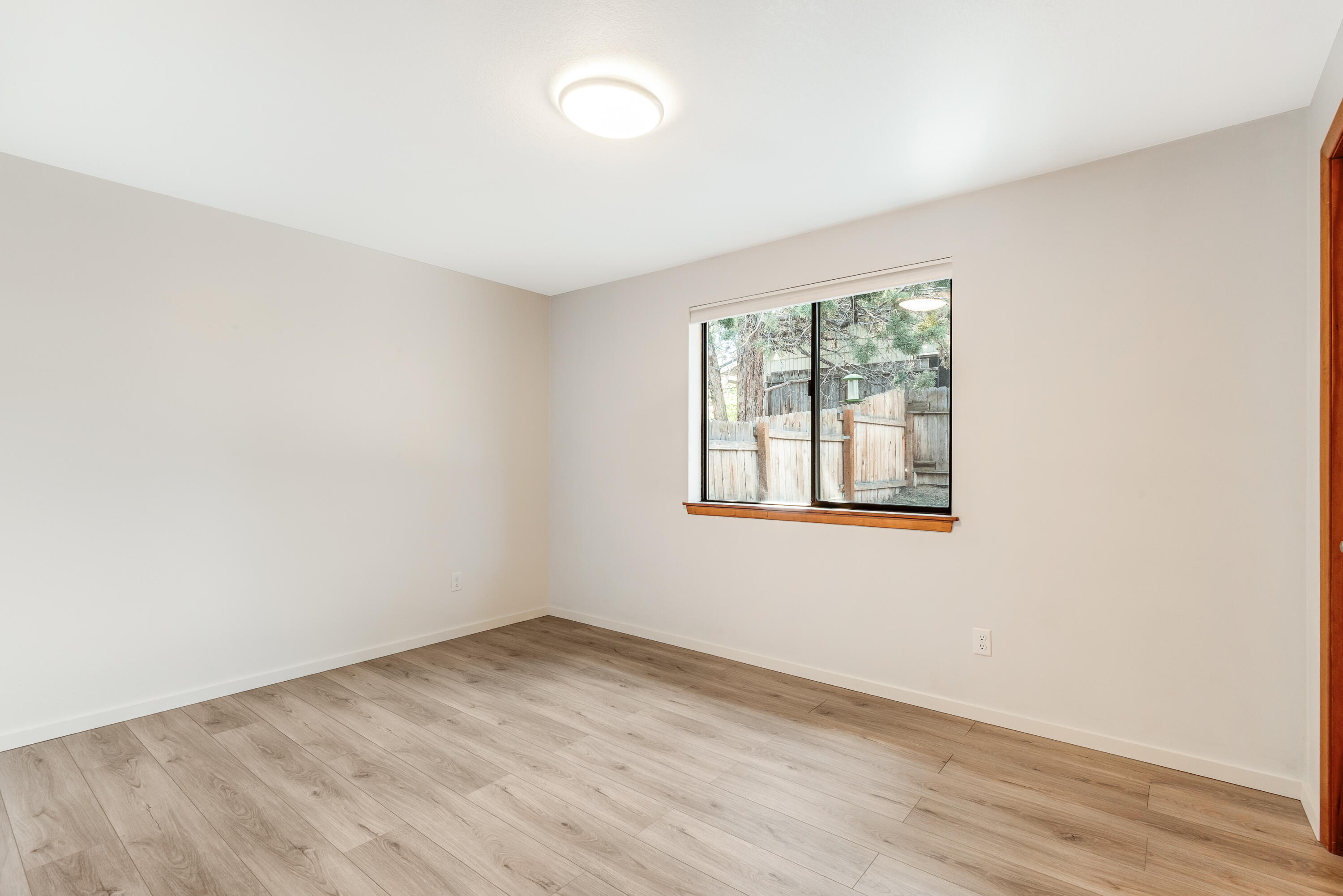 1916 Northeast Wichita Way Bend, OR 97701 - Photo 14 of 38 an empty room with wooden floor and windows