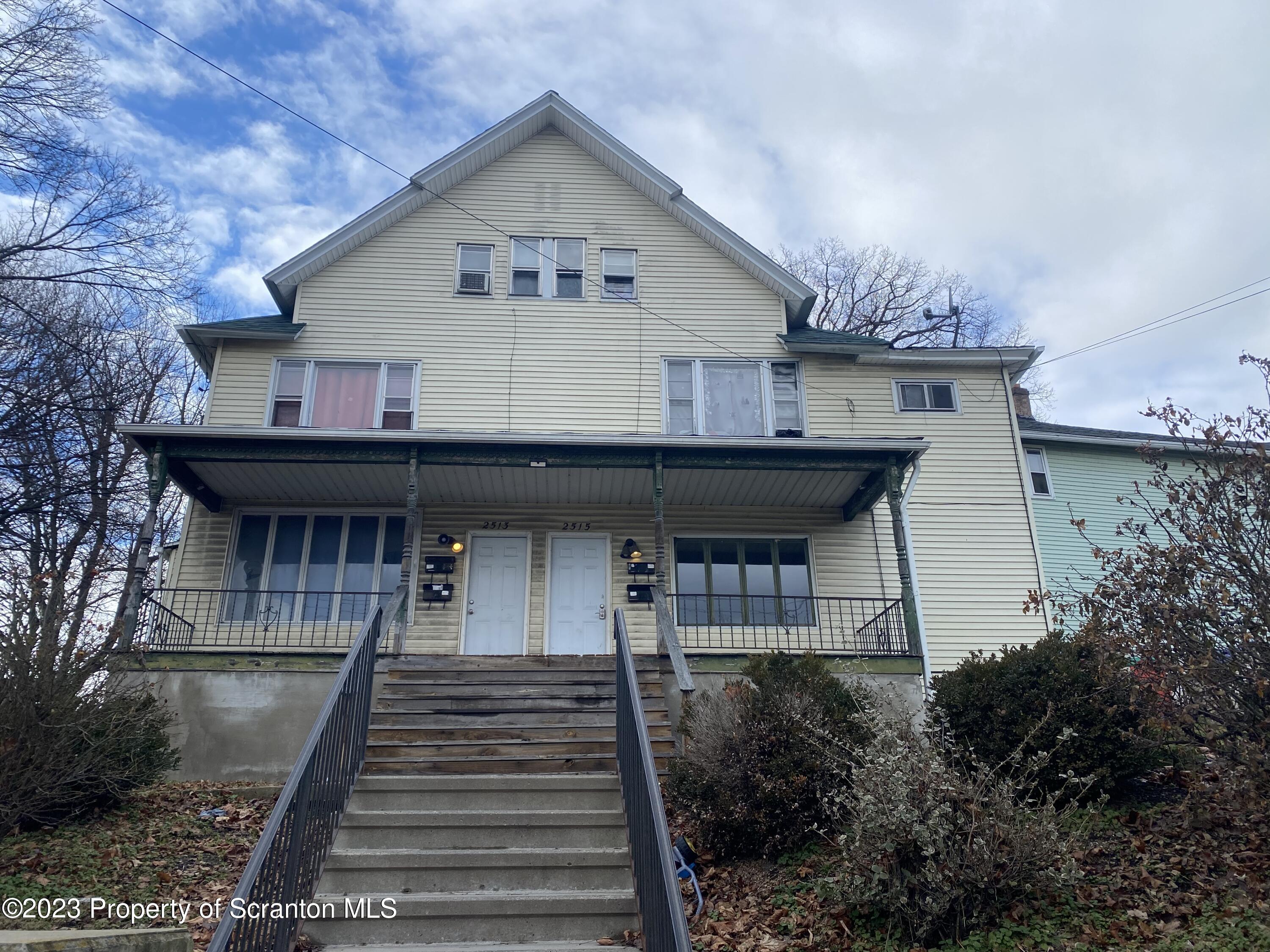2513 North Main Avenue Scranton, PA 18508 - Photo 1 of 17 a front view of a house with wooden stairs and seating space
