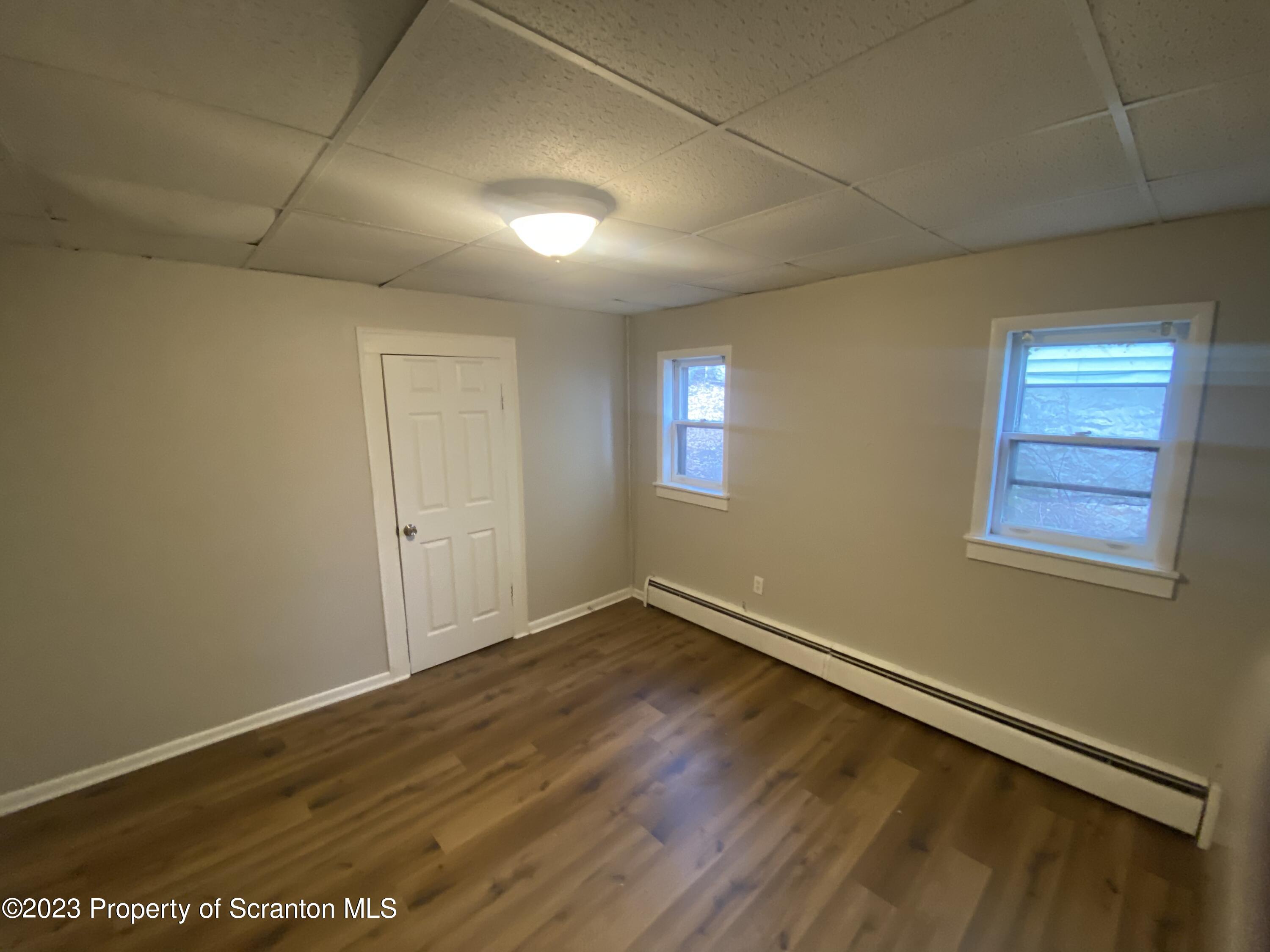 2513 North Main Avenue Scranton, PA 18508 - Photo 12 of 17 an empty room with wooden floor and windows
