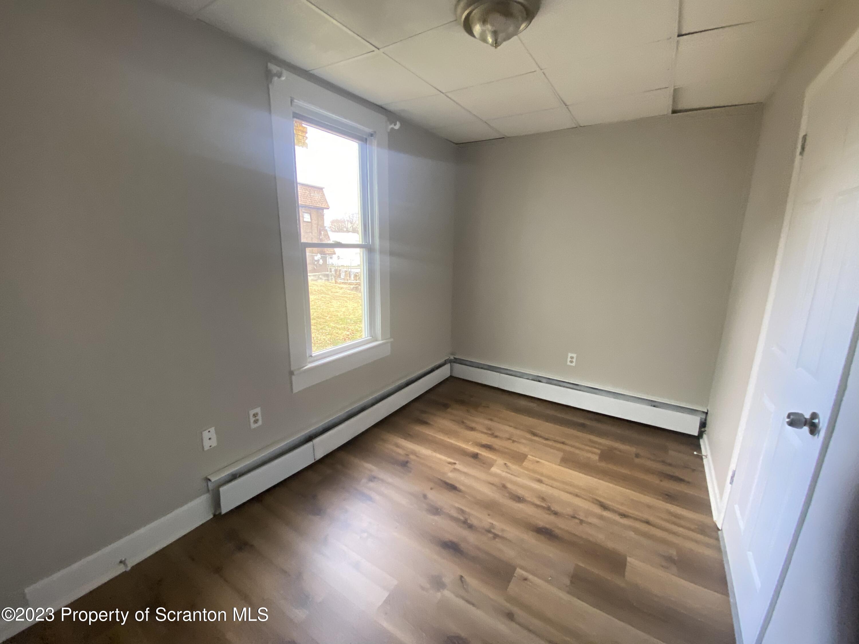 2513 North Main Avenue Scranton, PA 18508 - Photo 14 of 17 an empty room with wooden floor and windows