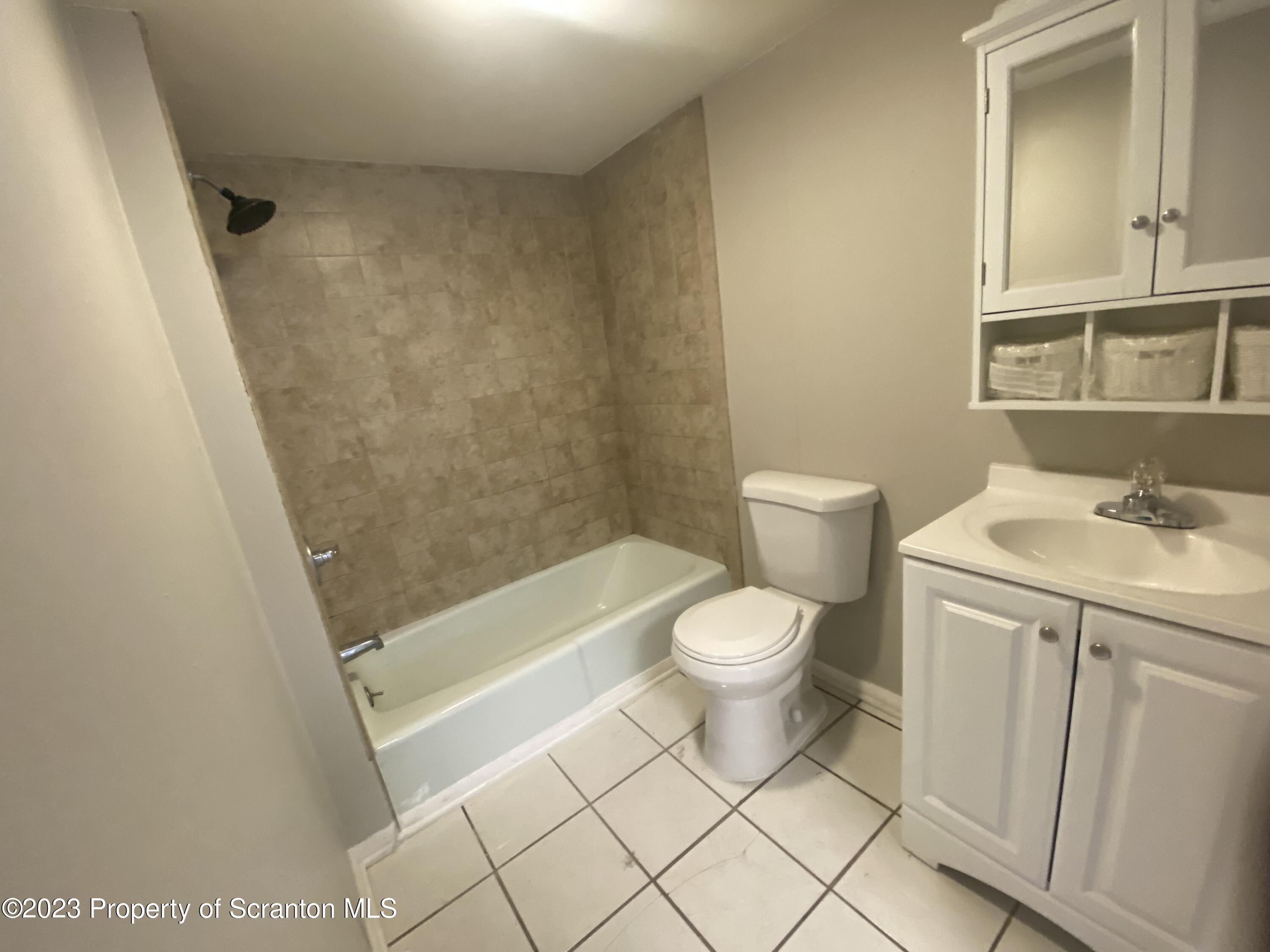 2513 North Main Avenue Scranton, PA 18508 - Photo 17 of 17 a bathroom with a toilet a sink and a mirror