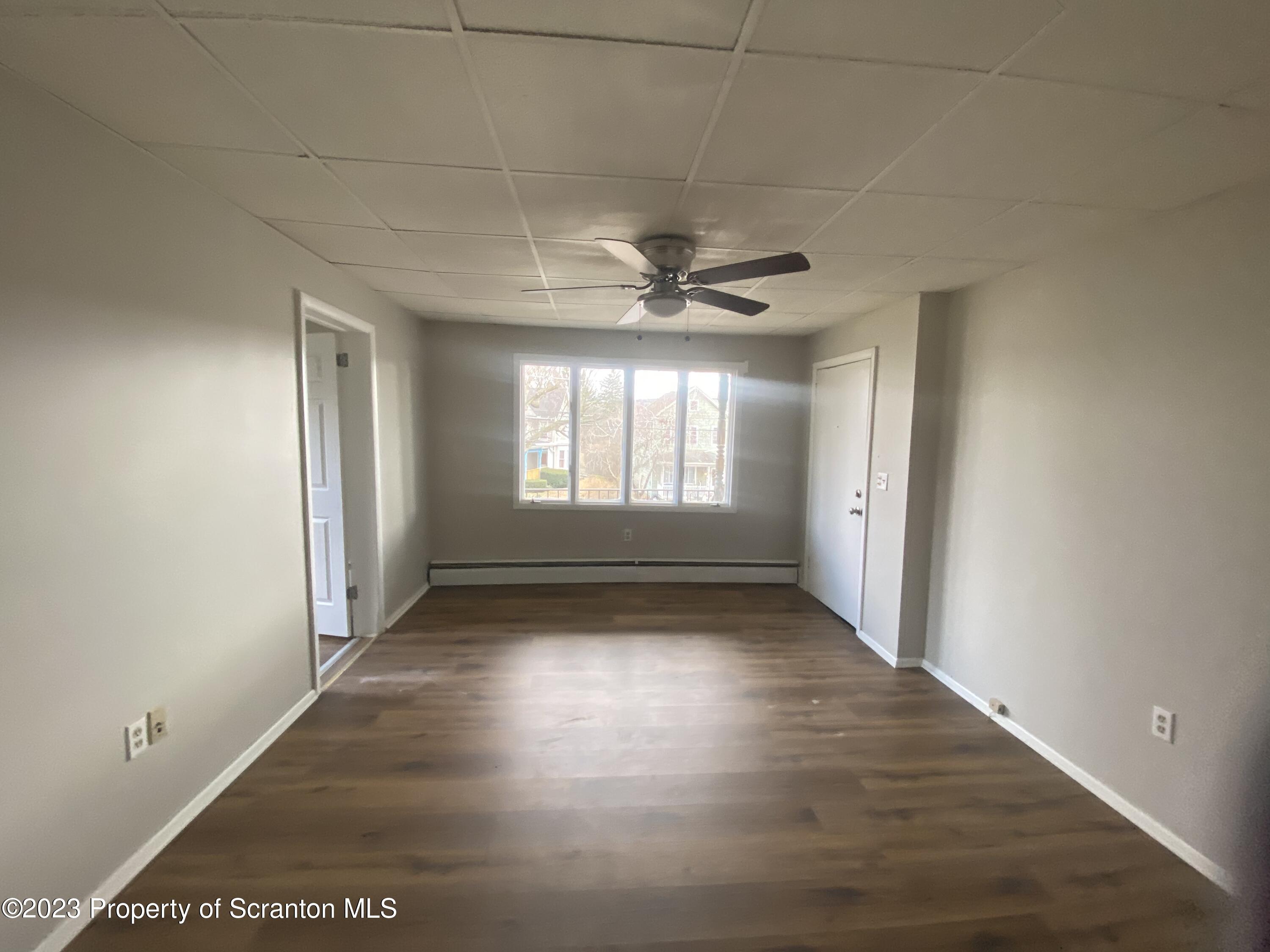 2513 North Main Avenue Scranton, PA 18508 - Photo 8 of 17 an empty room with wooden floor and windows