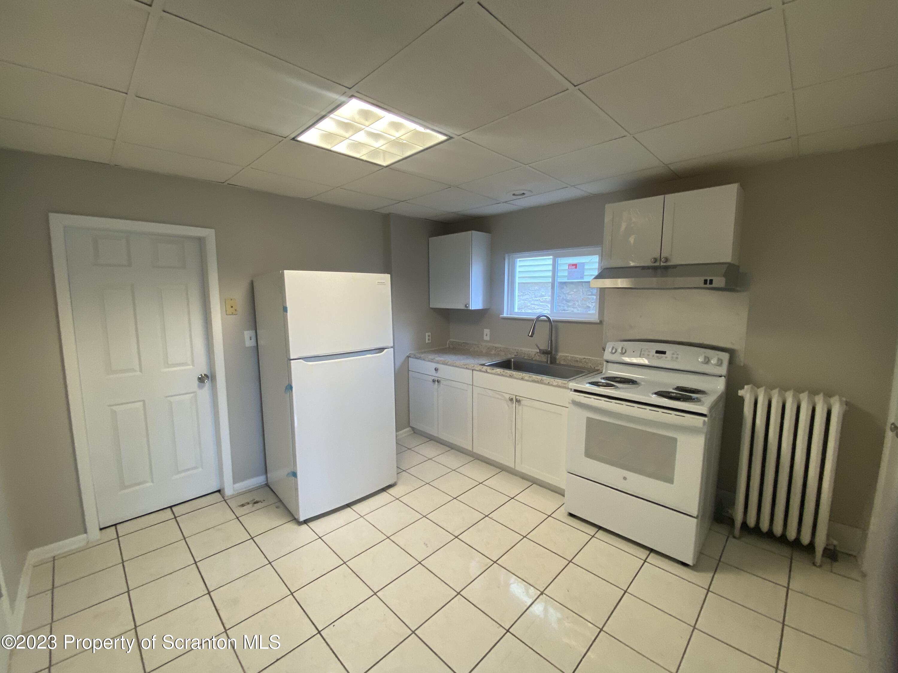 2513 North Main Avenue Scranton, PA 18508 - Photo 9 of 17 a kitchen with a cabinets and a refrigerator