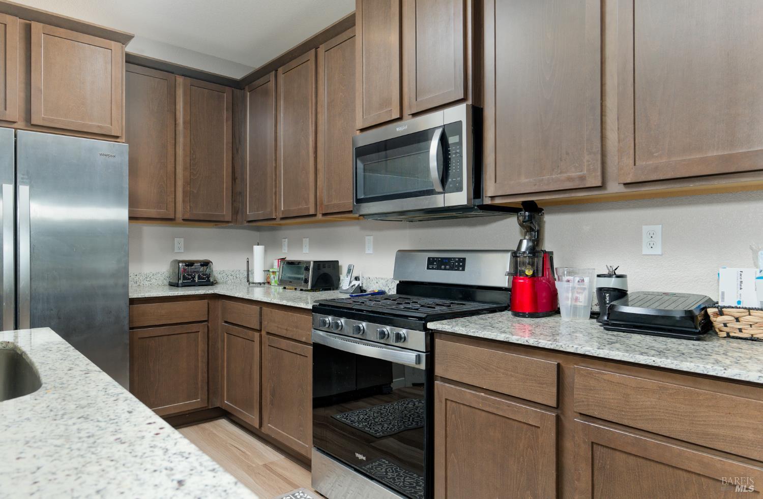 2211 Stars Drive Rio Vista, CA 94571 - Photo 8 of 24 a kitchen with stainless steel appliances granite countertop a sink stove and cabinets
