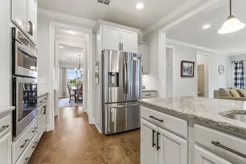a kitchen with stainless steel appliances granite countertop a refrigerator and a sink