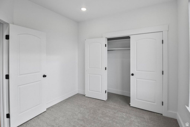 412 West 3025th Street South Logan, UT 84321 - Photo 27 of 34 Unfurnished bedroom featuring light carpet, a closet, and recessed lighting