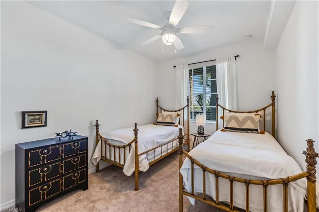 a bedroom with two beds and painting on the wall