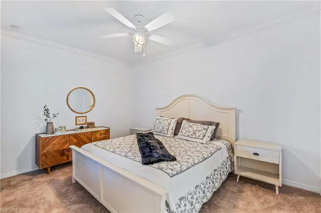 a bedroom with bed and a chandelier