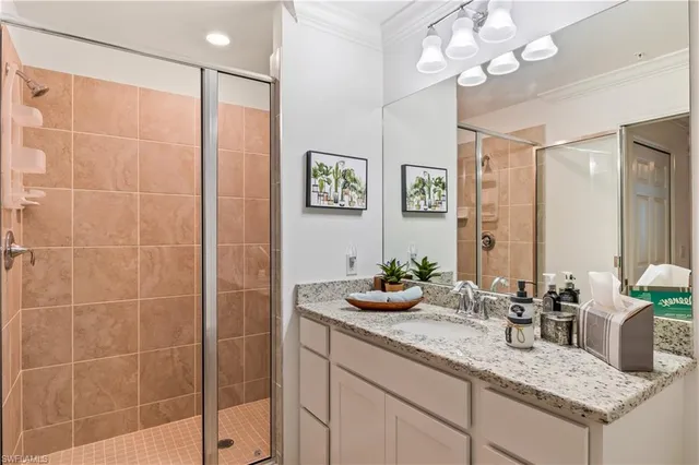 a bathroom with a granite countertop sink a mirror and vanity
