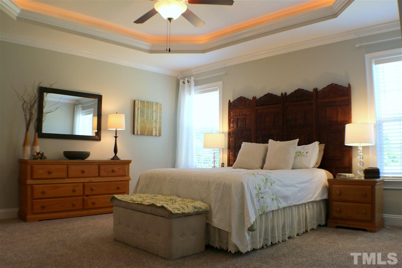 820 Hood Farm Road Clayton, NC 27520 - Photo 6 of 20 This bright and open First Floor Master features a tray ceiling with accent lighting & ceiling fan, access to the SCREENED PORCH, new carpet, & SPA LIKE BATH with WALK IN CLOSET.