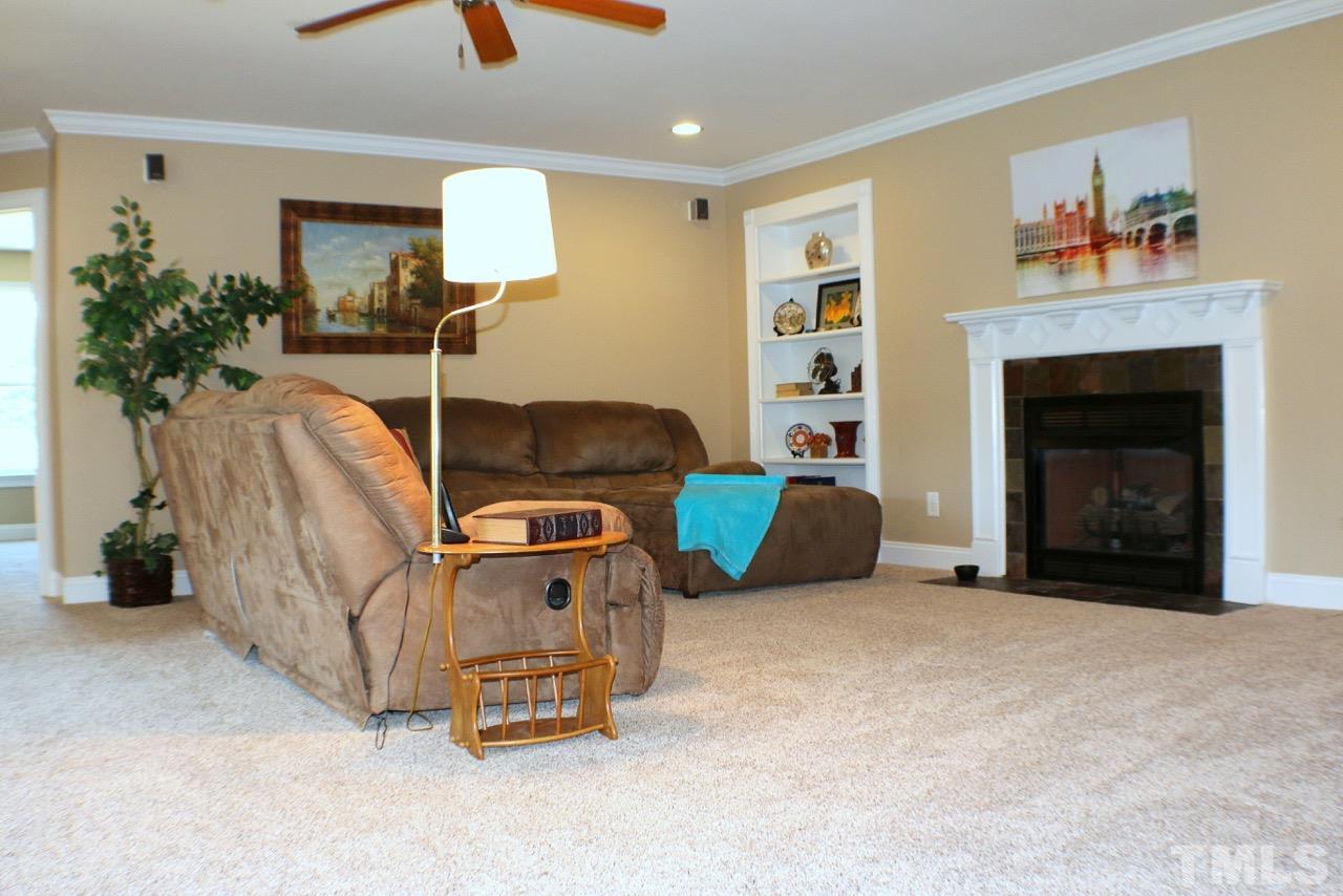 820 Hood Farm Road Clayton, NC 27520 - Photo 10 of 20 Extend your living area into this large Loft with GAS FIREPLACE, built in bookshelves, & ceiling fan. There is a hidden office area behind one of the bookshelves.