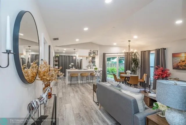 a view of a livingroom with furniture and a floor to ceiling window