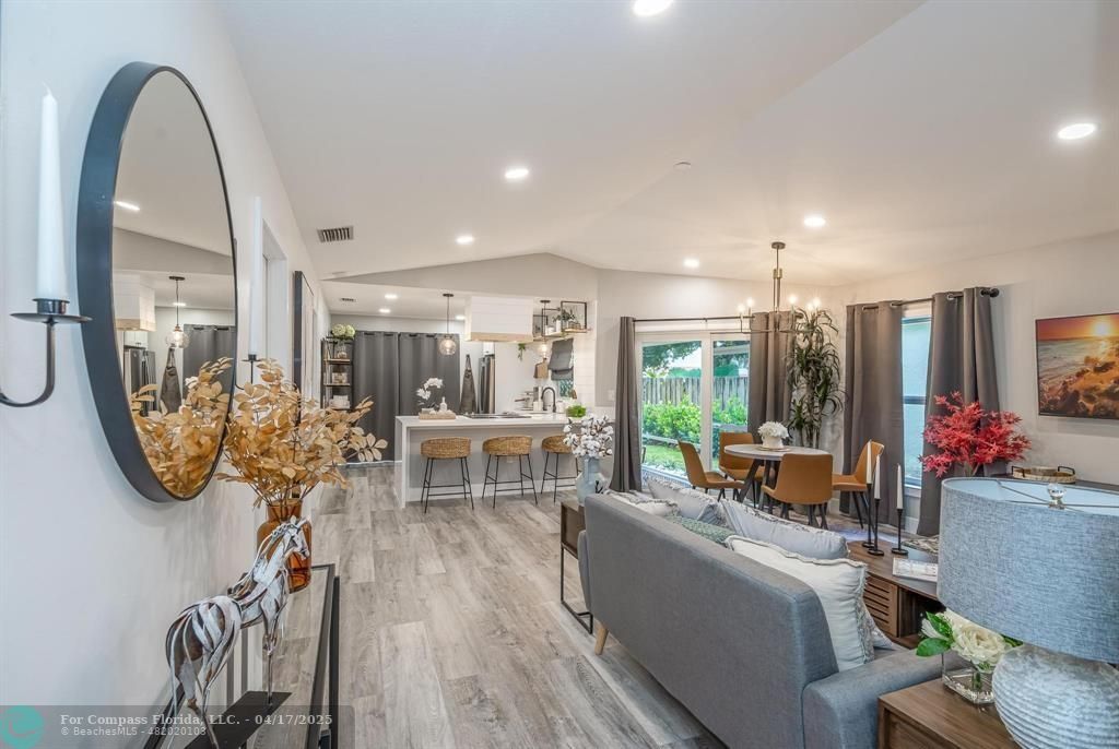 a view of a livingroom with furniture and a floor to ceiling window