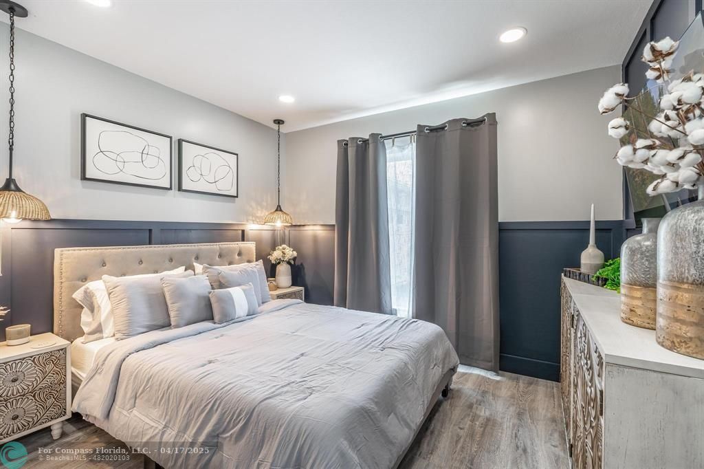 Undisclosed Address Davie, FL 33314 - Photo 13 of 23 a bedroom with a large bed and a chandelier