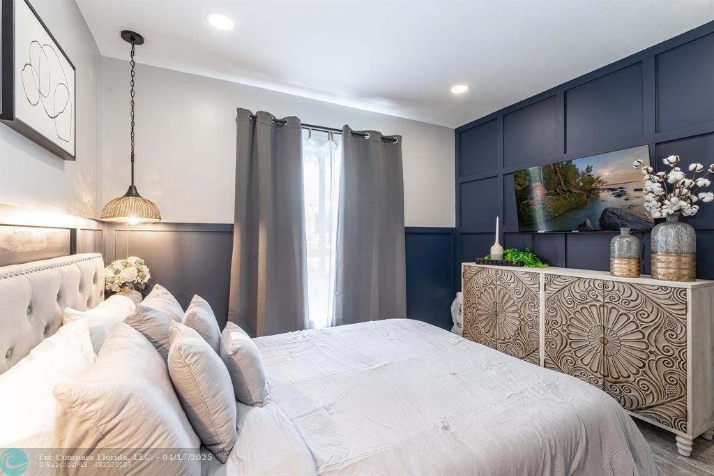 Undisclosed Address Davie, FL 33314 - Photo 14 of 23 a bedroom with a bed and a flat screen tv