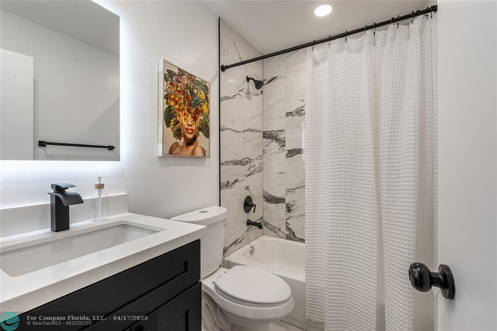 Undisclosed Address Davie, FL 33314 - Photo 16 of 23 a bathroom with a sink a toilet and shower curtain