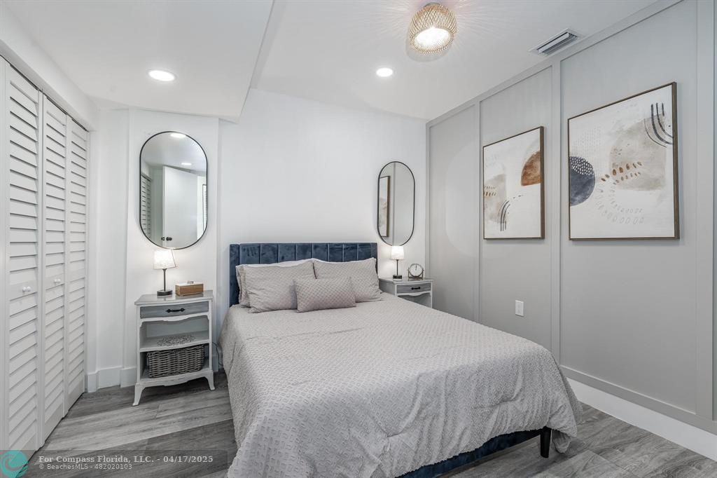 Undisclosed Address Davie, FL 33314 - Photo 17 of 23 a bedroom with a bed a mirror and wall painting