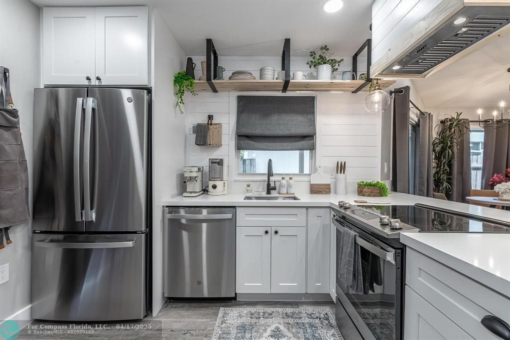 Undisclosed Address Davie, FL 33314 - Photo 4 of 23 a kitchen with stainless steel appliances a refrigerator sink and stove