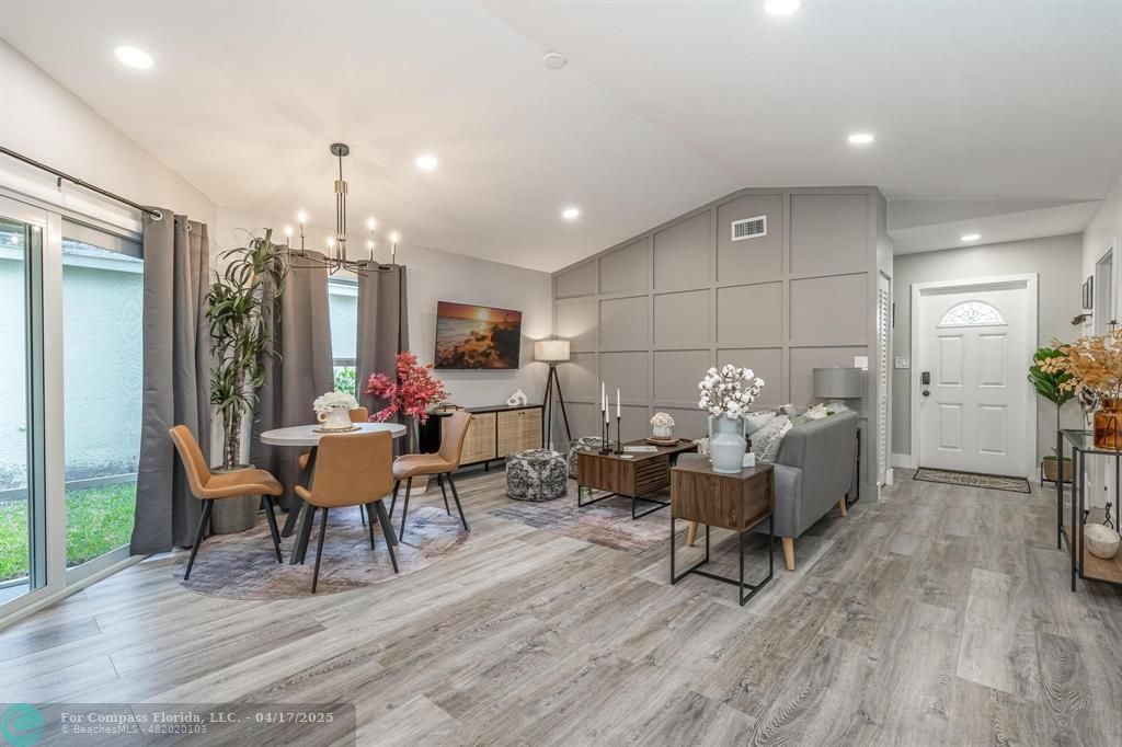 Undisclosed Address Davie, FL 33314 - Photo 6 of 23 a living room with furniture and a dining table with kitchen view