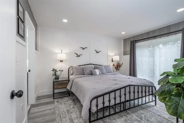 a bedroom with a bed and a potted plant