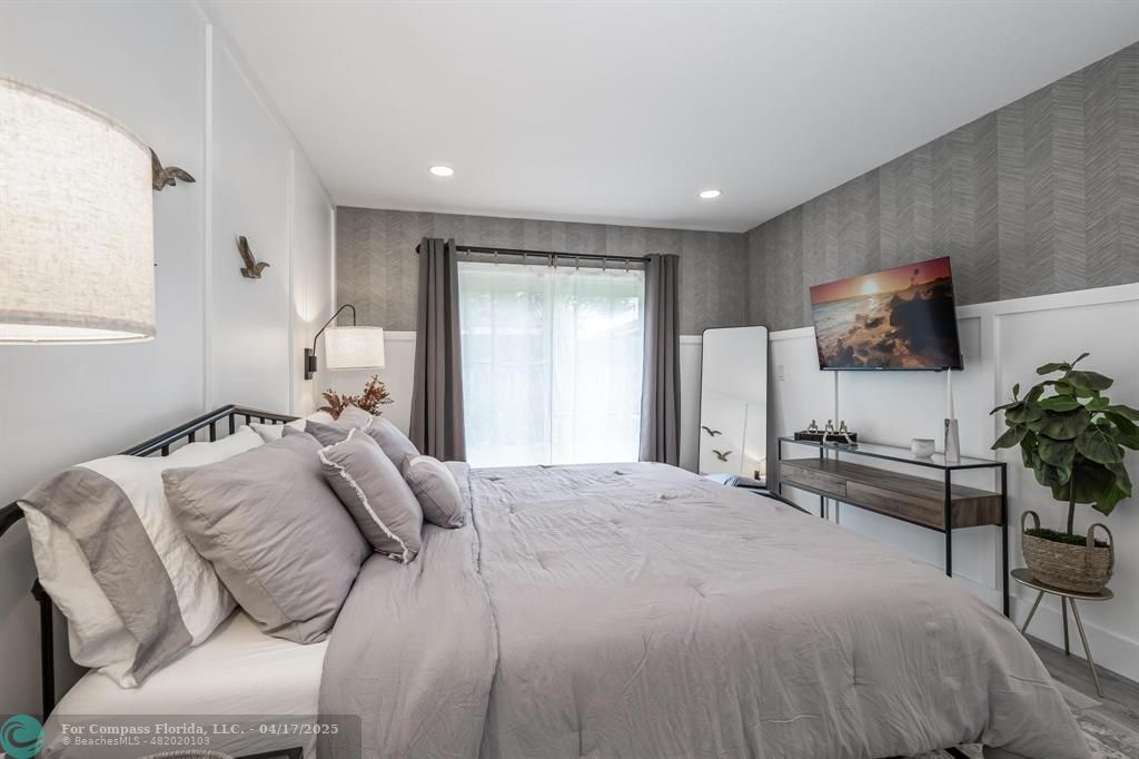 Undisclosed Address Davie, FL 33314 - Photo 10 of 23 a bedroom with a bed and a flat screen tv