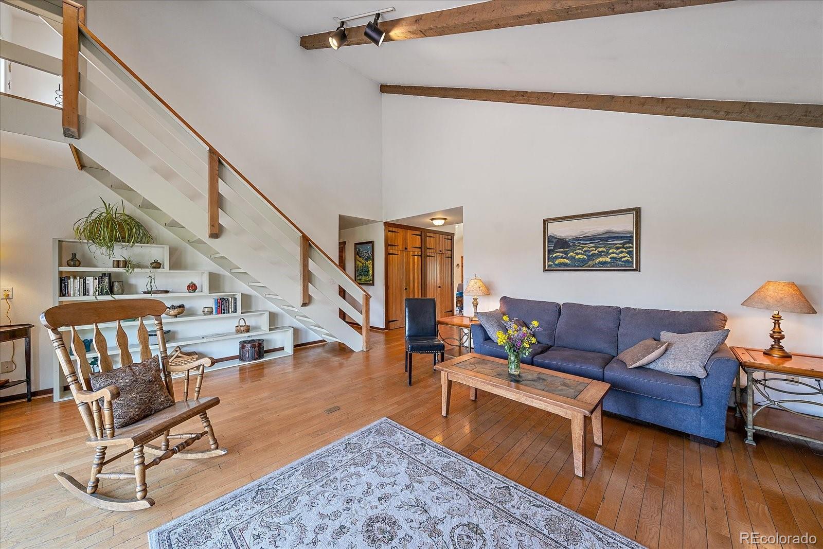 14482 Jubilee Trail Pine, CO 80470 - Photo 11 of 40 a living room with furniture and a wooden floor