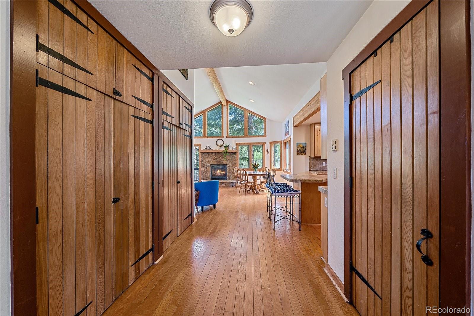 14482 Jubilee Trail Pine, CO 80470 - Photo 12 of 40 a view of living room kitchen with furniture and wooden floor