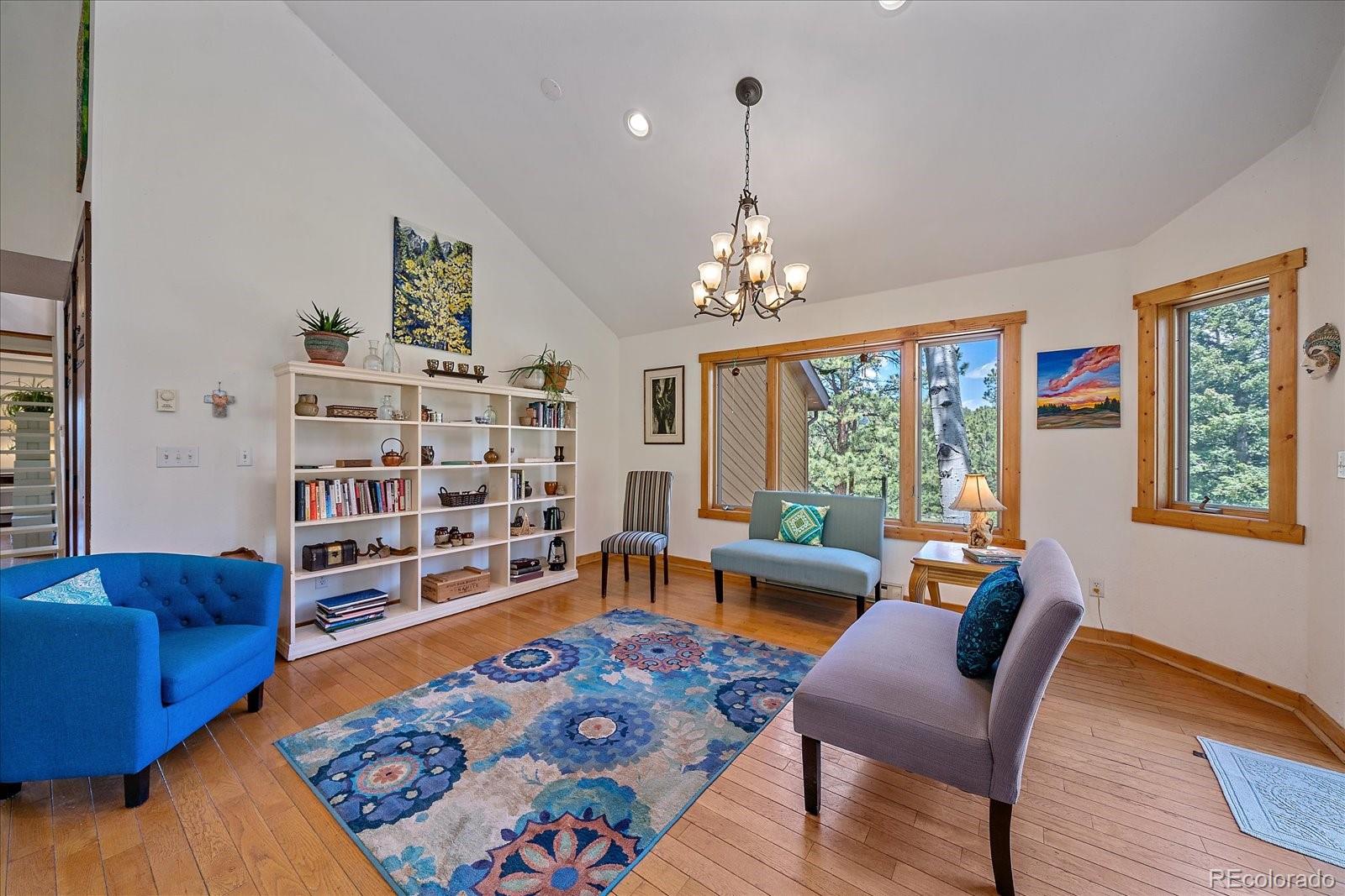14482 Jubilee Trail Pine, CO 80470 - Photo 16 of 40 a living room with furniture and a wooden floor