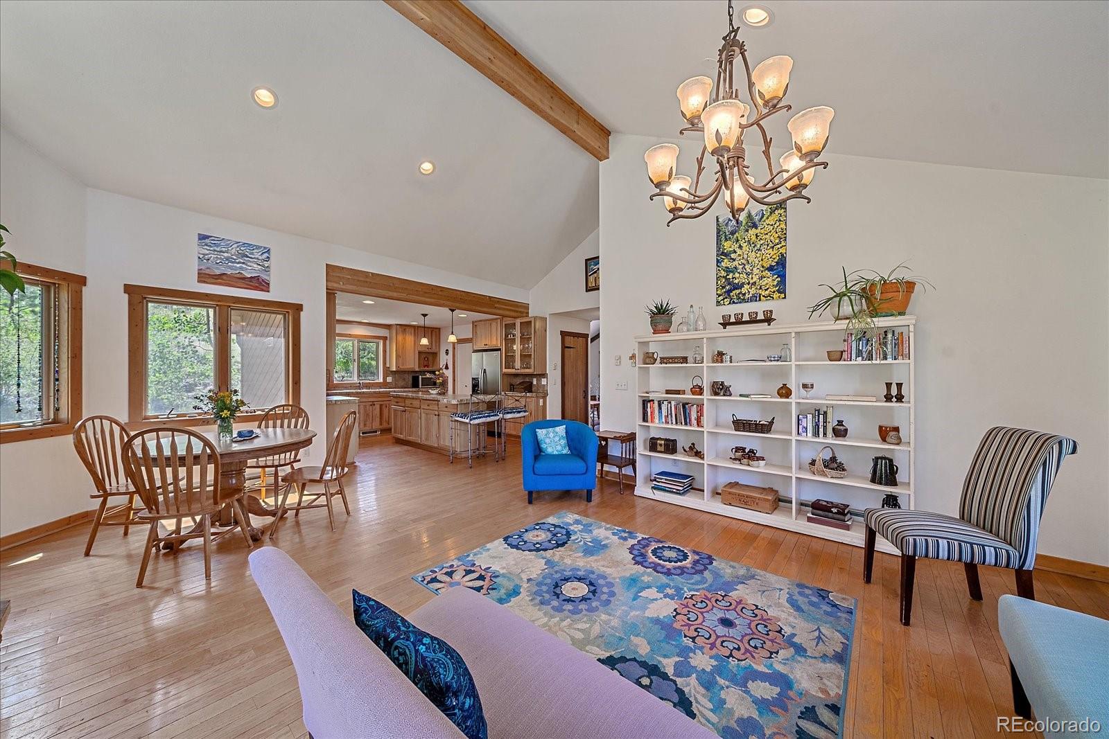 14482 Jubilee Trail Pine, CO 80470 - Photo 17 of 40 a living room with furniture wooden floor and chandelier
