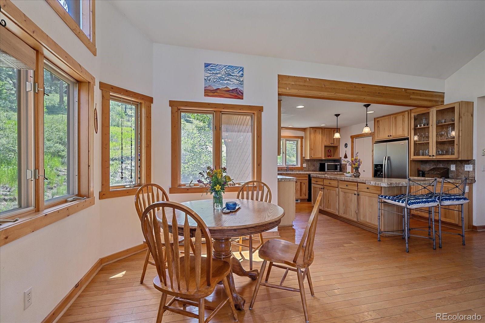14482 Jubilee Trail Pine, CO 80470 - Photo 18 of 40 a view of a dining room with furniture window and outside view