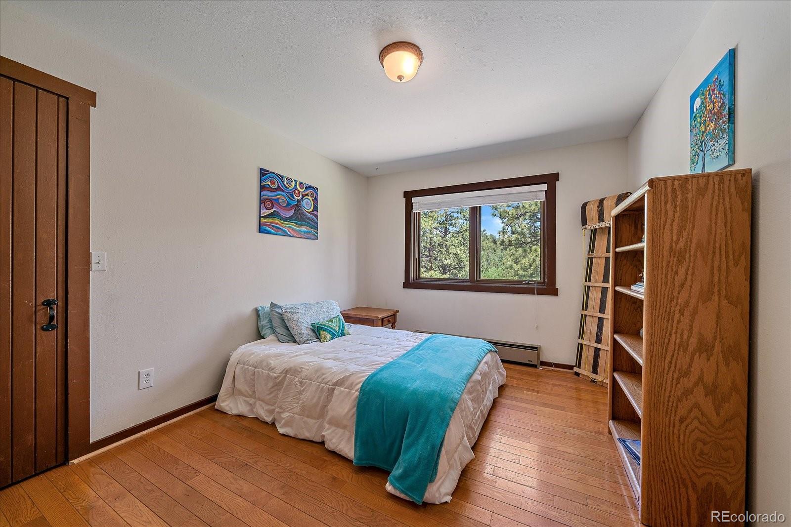 14482 Jubilee Trail Pine, CO 80470 - Photo 24 of 40 a bedroom with a bed and a window