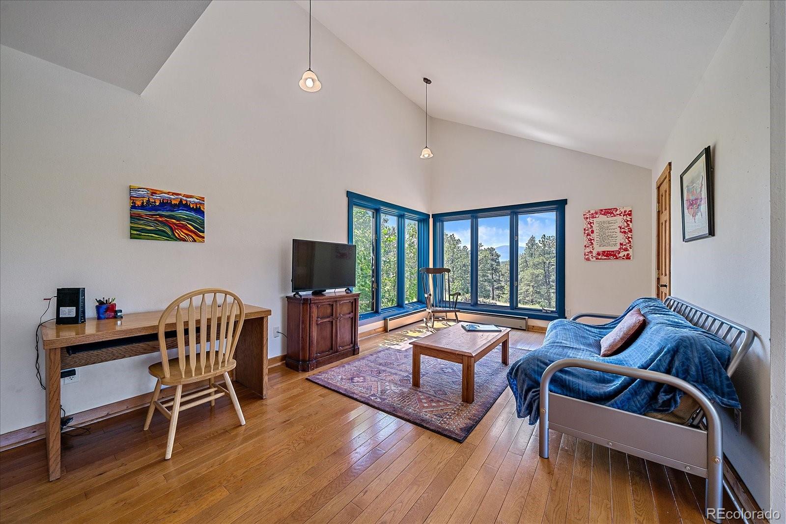 14482 Jubilee Trail Pine, CO 80470 - Photo 27 of 40 a living room with furniture and a flat screen tv