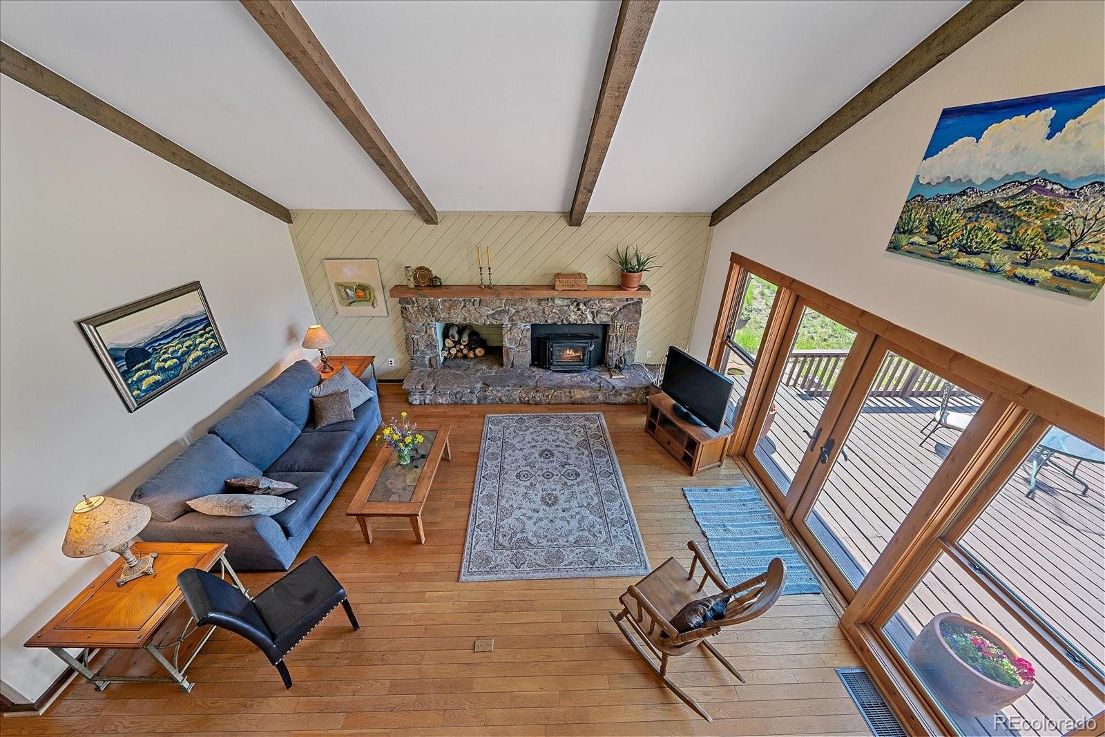 14482 Jubilee Trail Pine, CO 80470 - Photo 29 of 40 a living room with chairs and a rug
