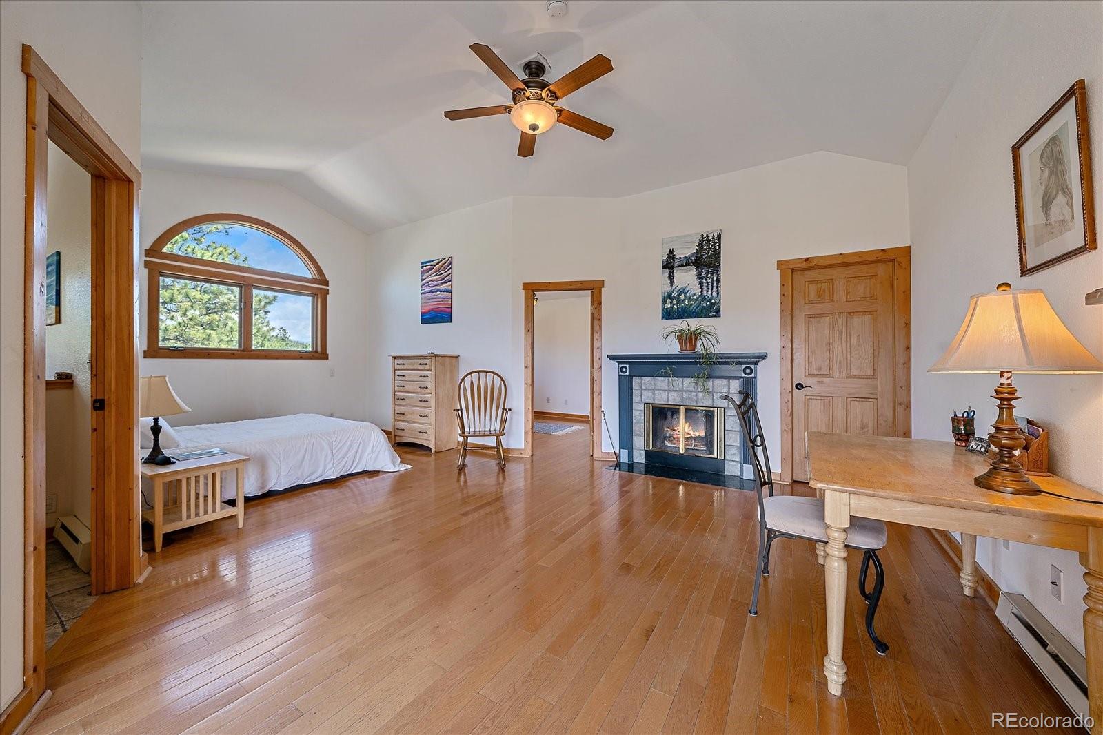 14482 Jubilee Trail Pine, CO 80470 - Photo 30 of 40 a living room with furniture and a fireplace