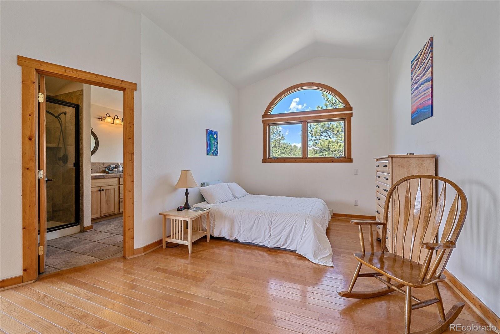 14482 Jubilee Trail Pine, CO 80470 - Photo 31 of 40 a bedroom with a bed and a window