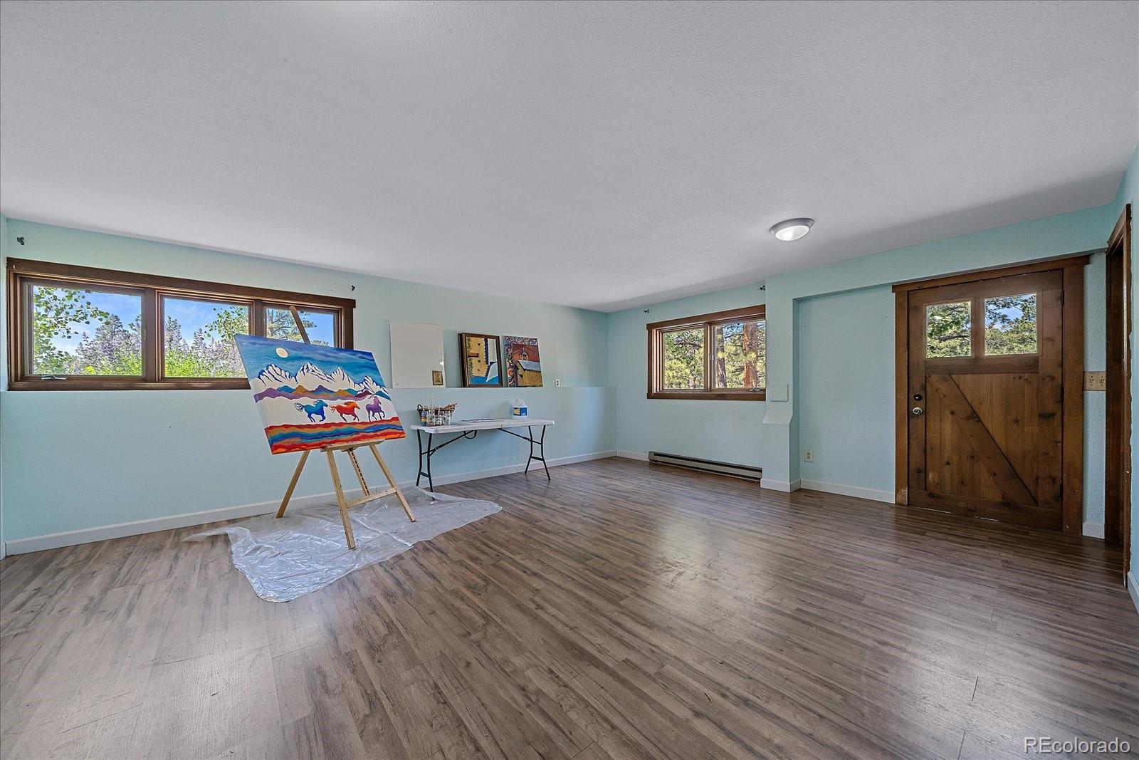 14482 Jubilee Trail Pine, CO 80470 - Photo 35 of 40 a living room with furniture and a wooden floor