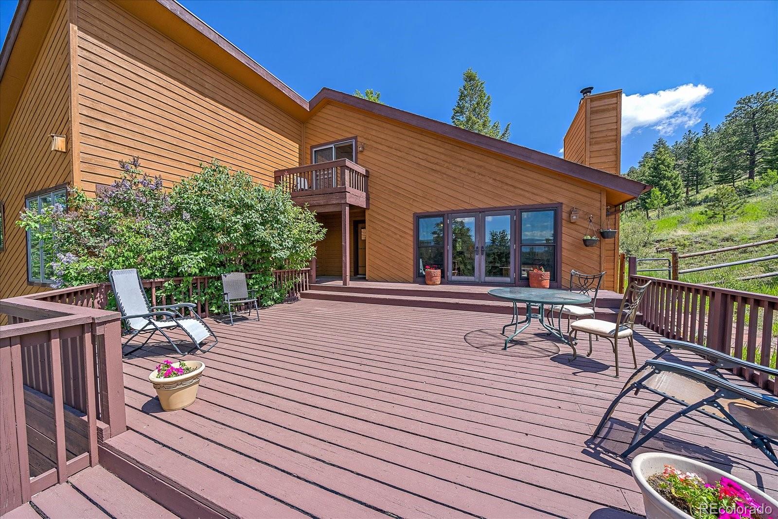 14482 Jubilee Trail Pine, CO 80470 - Photo 4 of 40 a view of a patio with wooden floor