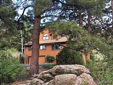 14482 Jubilee Trail Pine, CO 80470 - Photo 5 of 40 a view of a house with a tree