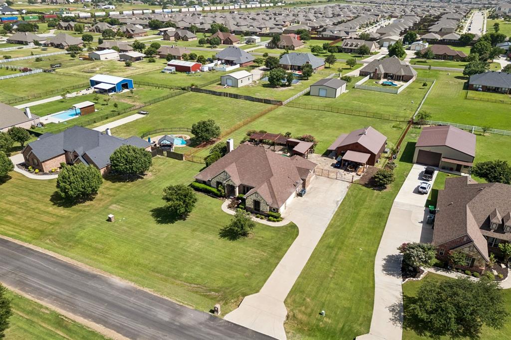 317 Singing Quail Trail Haslet, TX 76052 - Photo 31 of 32 Expansive property featuring a large residence, a separate auxiliary building, a dedicated workshop structure, a private swimming pool, and extensive manicured lawns