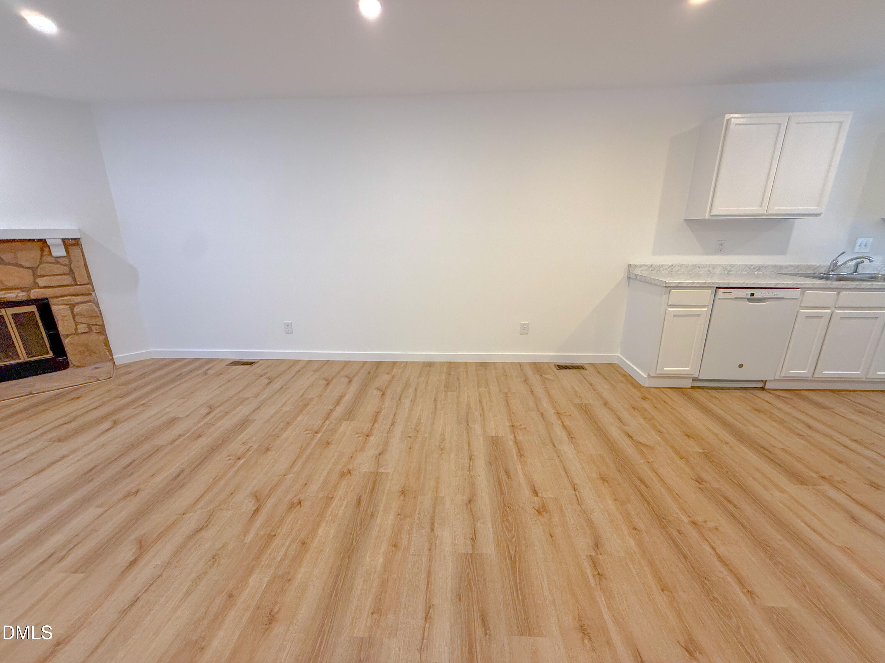 4247 The Oaks Drive Raleigh, NC 27606 - Photo 6 of 21 a view of a room with wooden floor and cabinets