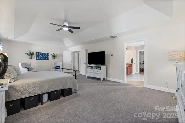 a living room with a bed furniture and a flat screen tv