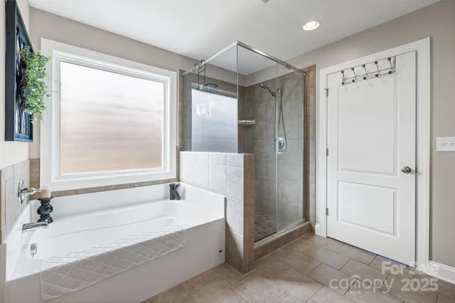 a bathroom with a bathtub and a shower